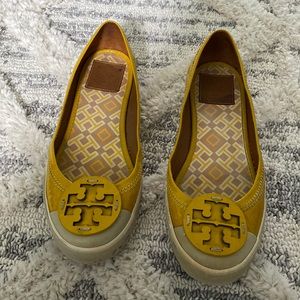 Tory Burch yellow slip-ons.